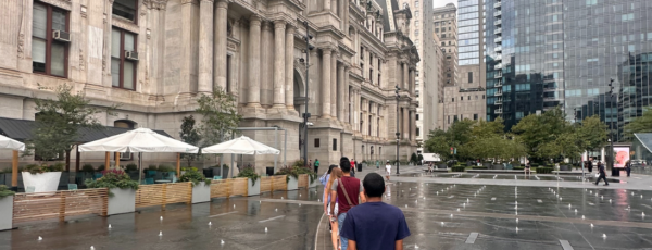 Students walk through the splash fountain in front of City Hall