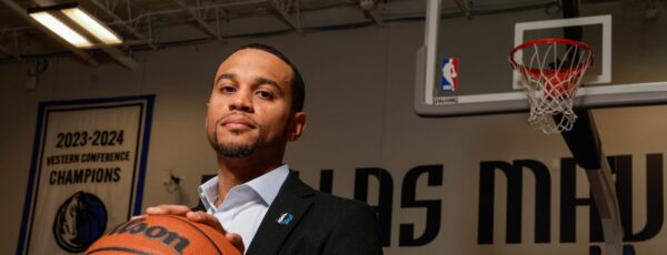 Man in a suit holding a basketball